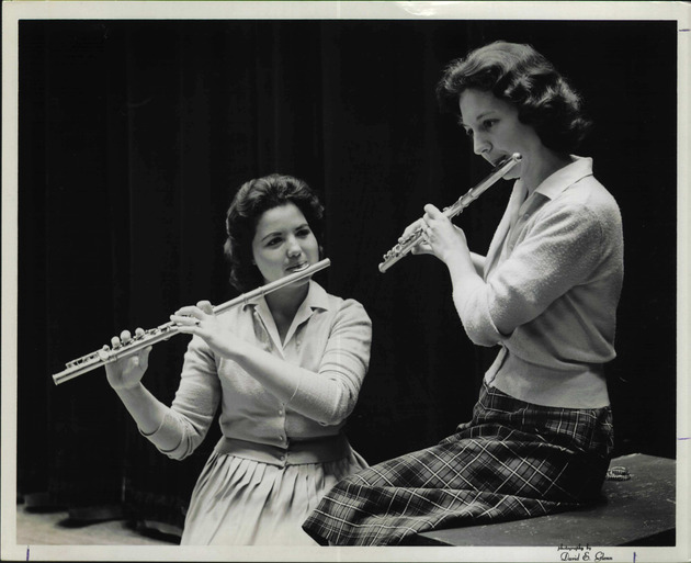 Two flautists playing together on a stage